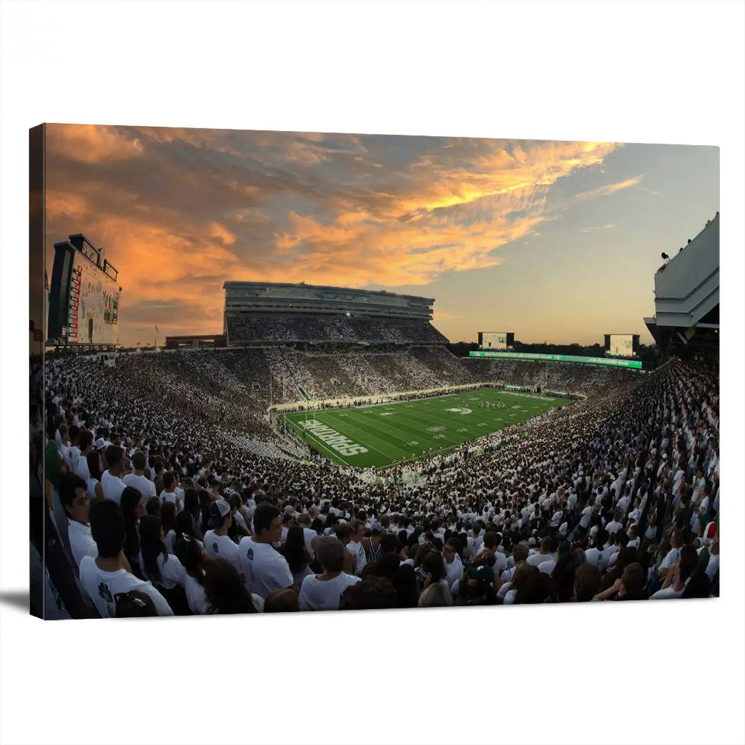 A living room showcasing a stunning Michigan State Spartans Football Team Print on a three-panel canvas, depicting the bustling Spartan Stadium in East Lansing at sunset, all handmade in the USA.