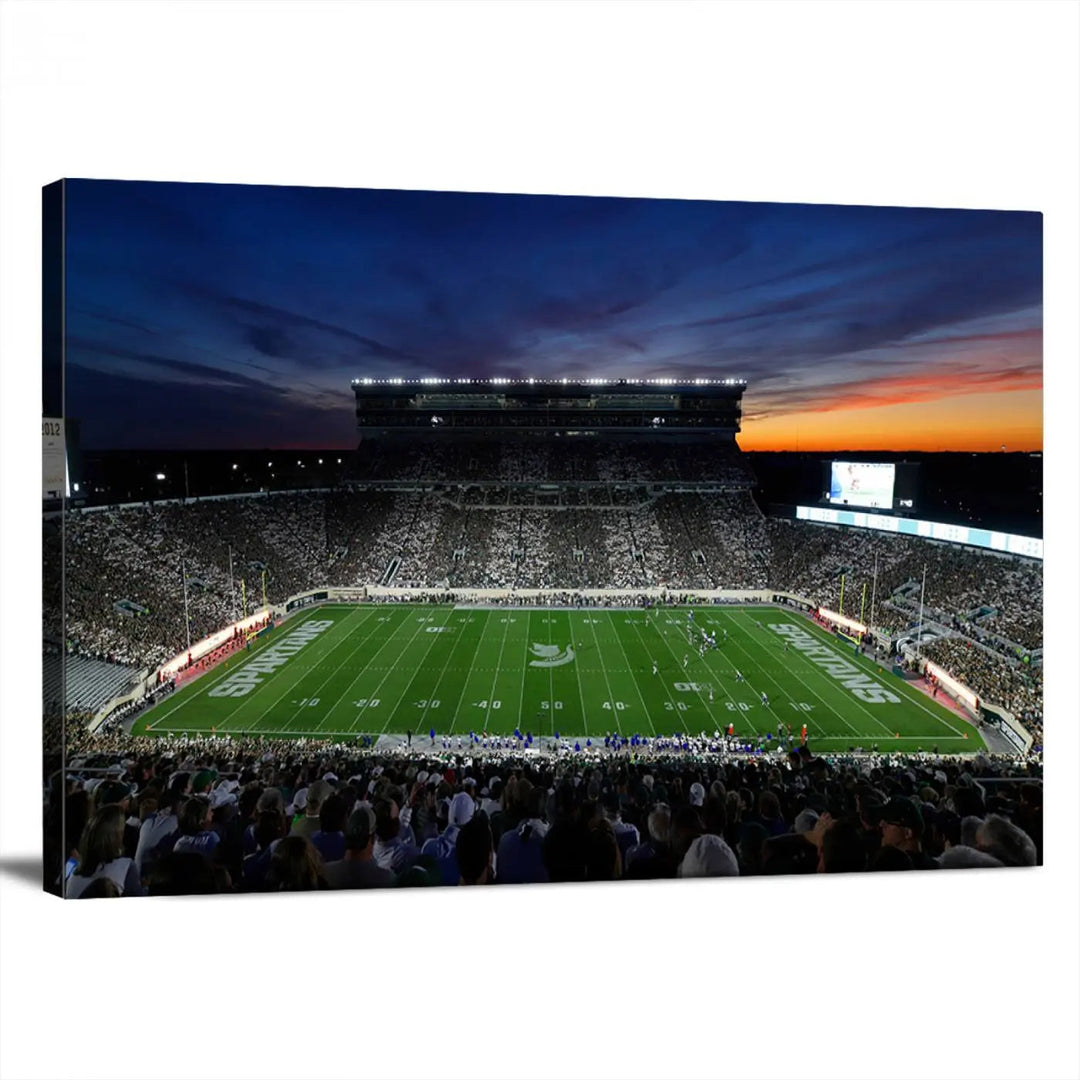 The room showcases a triptych wall art featuring the Michigan State Spartans football team at East Lansing Spartan Stadium at dusk, elegantly printed on premium canvas for a gallery-quality finish.