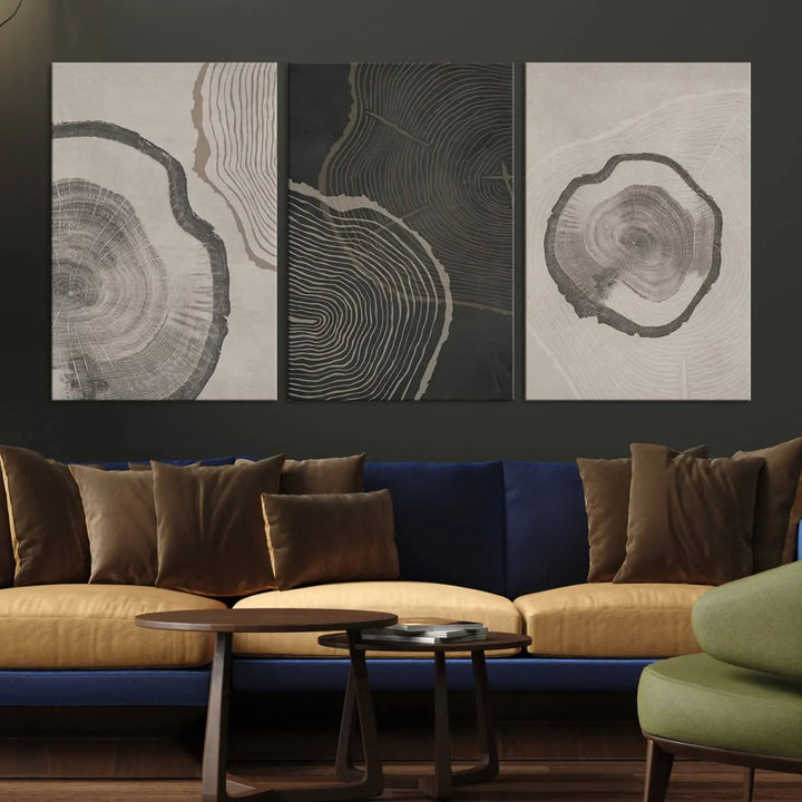 A remarkable set of "Modern Abstract Tree Ring Canvas Art" featuring three panels with large tree ring designs hangs prominently, adding to the minimalistic elegance of the living room.