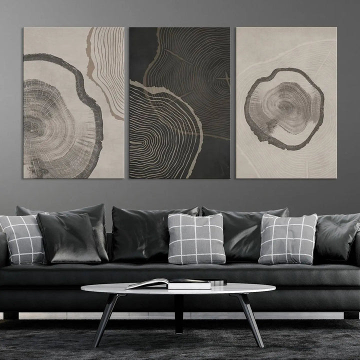 A remarkable set of "Modern Abstract Tree Ring Canvas Art" featuring three panels with large tree ring designs hangs prominently, adding to the minimalistic elegance of the living room.