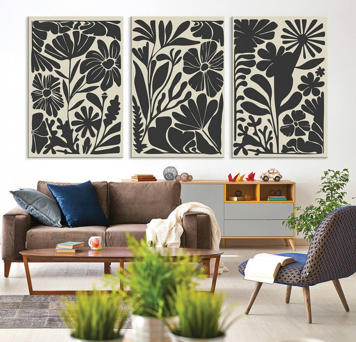 A modern living room features framed black & white botanical wall art that adds flair.