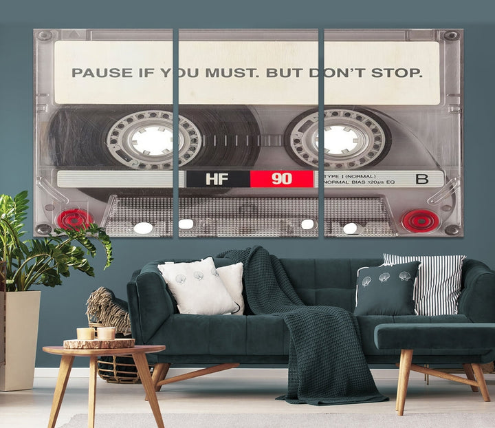 The Music Cassette Iconic Wall Art Canvas Print features a cassette tape with the inspiring message "Pause if you must. But don't stop." It is elegantly printed on museum-quality canvas with a UV-protective coating to ensure long-lasting vibrancy. This gallery-wrapped piece is perfect for any modern space.