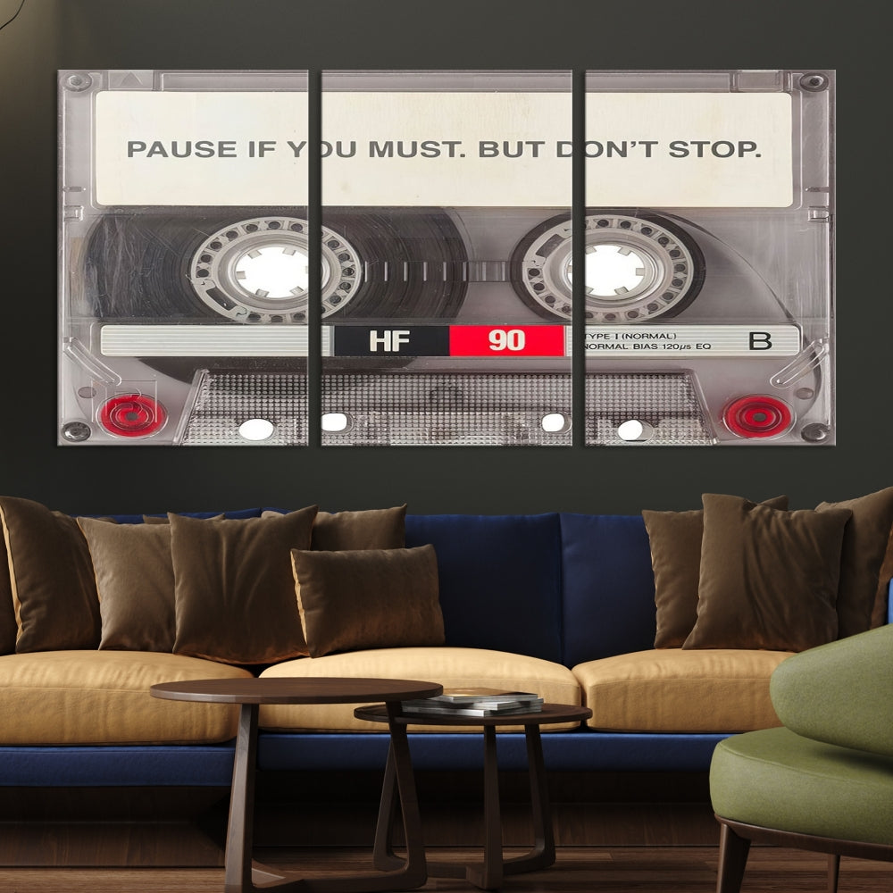 The Music Cassette Iconic Wall Art Canvas Print features a cassette tape with the inspiring message "Pause if you must. But don't stop." It is elegantly printed on museum-quality canvas with a UV-protective coating to ensure long-lasting vibrancy. This gallery-wrapped piece is perfect for any modern space.