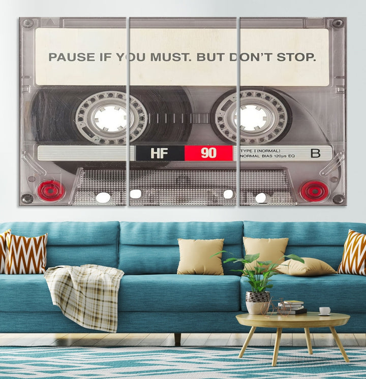 The Music Cassette Iconic Wall Art Canvas Print features a cassette tape with the inspiring message "Pause if you must. But don't stop." It is elegantly printed on museum-quality canvas with a UV-protective coating to ensure long-lasting vibrancy. This gallery-wrapped piece is perfect for any modern space.