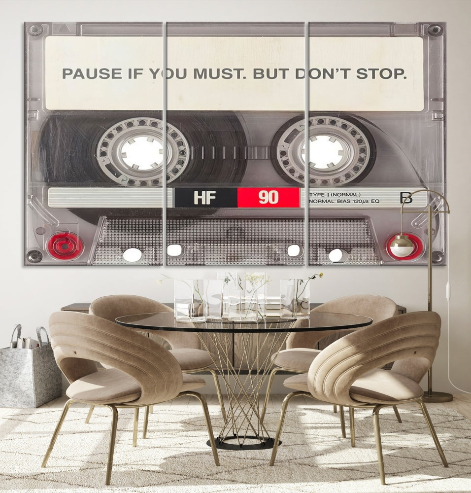 The Music Cassette Iconic Wall Art Canvas Print features a cassette tape with the inspiring message "Pause if you must. But don't stop." It is elegantly printed on museum-quality canvas with a UV-protective coating to ensure long-lasting vibrancy. This gallery-wrapped piece is perfect for any modern space.