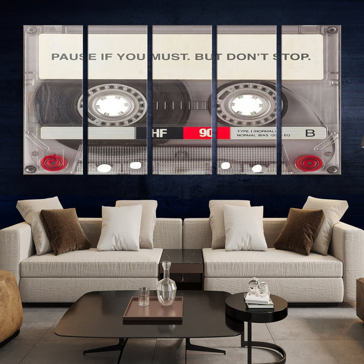 The Music Cassette Iconic Wall Art Canvas Print features a cassette tape with the inspiring message "Pause if you must. But don't stop." It is elegantly printed on museum-quality canvas with a UV-protective coating to ensure long-lasting vibrancy. This gallery-wrapped piece is perfect for any modern space.