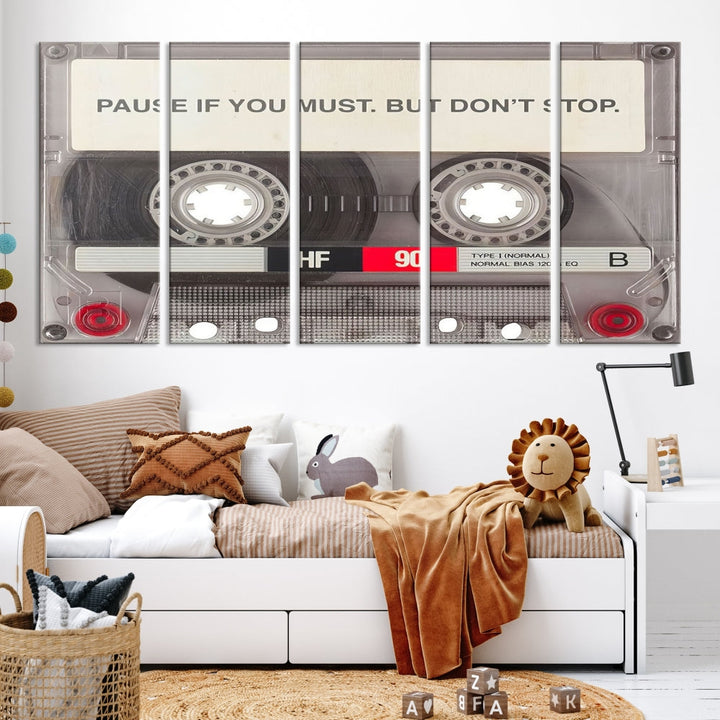 The Music Cassette Iconic Wall Art Canvas Print features a cassette tape with the inspiring message "Pause if you must. But don't stop." It is elegantly printed on museum-quality canvas with a UV-protective coating to ensure long-lasting vibrancy. This gallery-wrapped piece is perfect for any modern space.