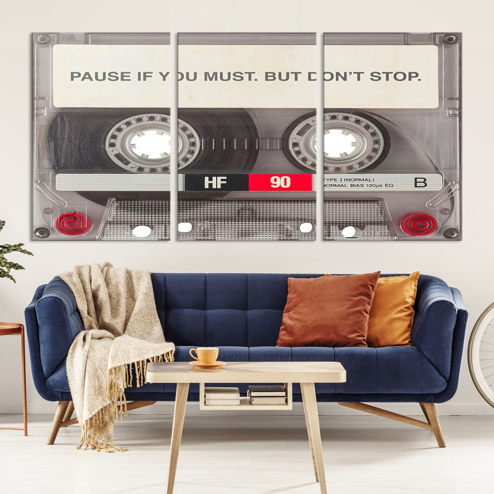 The Music Cassette Iconic Wall Art Canvas Print features a cassette tape with the inspiring message "Pause if you must. But don't stop." It is elegantly printed on museum-quality canvas with a UV-protective coating to ensure long-lasting vibrancy. This gallery-wrapped piece is perfect for any modern space.