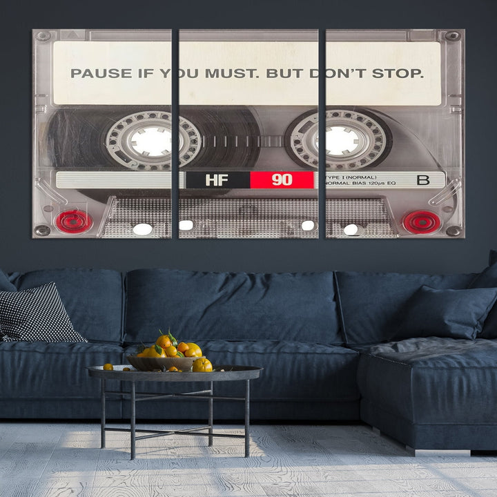 The Music Cassette Iconic Wall Art Canvas Print features a cassette tape with the inspiring message "Pause if you must. But don't stop." It is elegantly printed on museum-quality canvas with a UV-protective coating to ensure long-lasting vibrancy. This gallery-wrapped piece is perfect for any modern space.