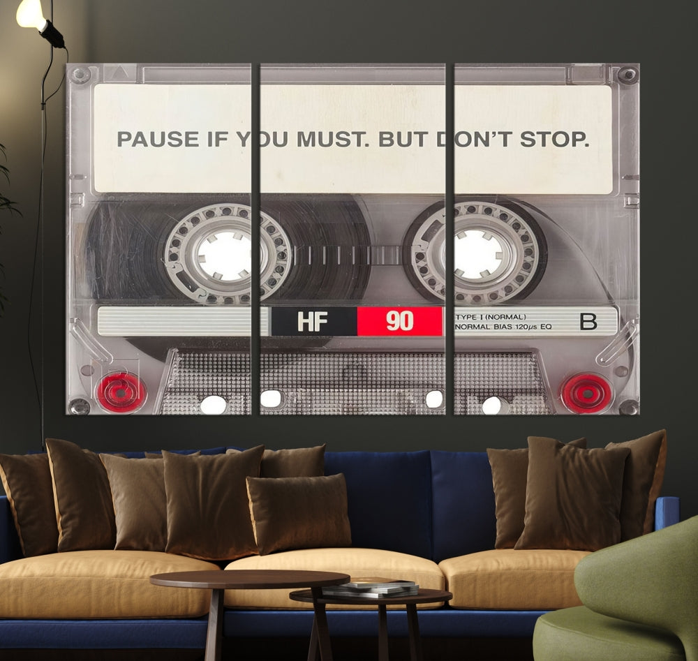 The Music Cassette Iconic Wall Art Canvas Print features a cassette tape with the inspiring message "Pause if you must. But don't stop." It is elegantly printed on museum-quality canvas with a UV-protective coating to ensure long-lasting vibrancy. This gallery-wrapped piece is perfect for any modern space.