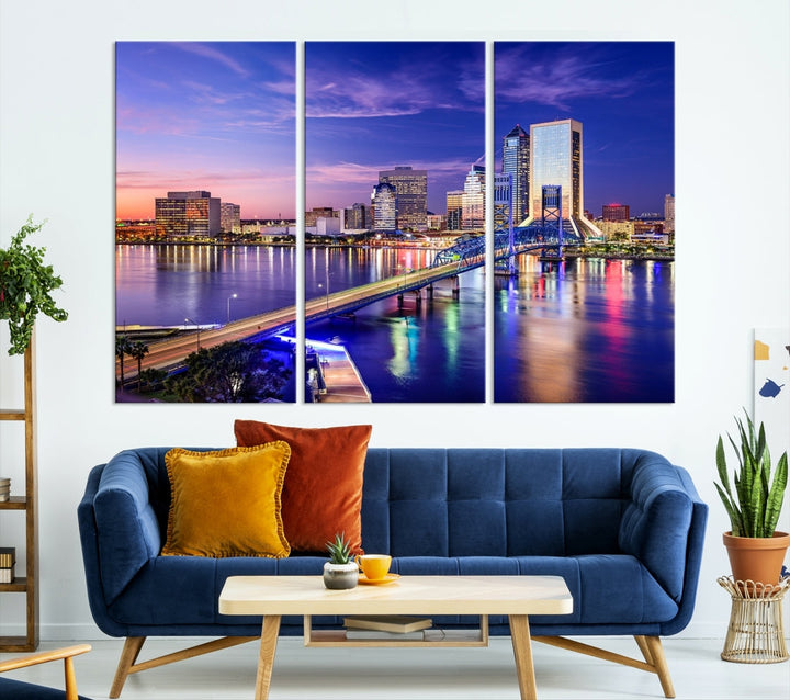 A triptych of the Jacksonville Wall Art Canvas Print, showcasing a cityscape at dusk with a river and illuminated buildings, is elegantly displayed. These museum-quality canvases are coated with UV protection to ensure long-lasting vibrancy.