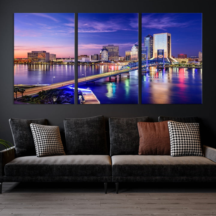 A triptych of the Jacksonville Wall Art Canvas Print, showcasing a cityscape at dusk with a river and illuminated buildings, is elegantly displayed. These museum-quality canvases are coated with UV protection to ensure long-lasting vibrancy.