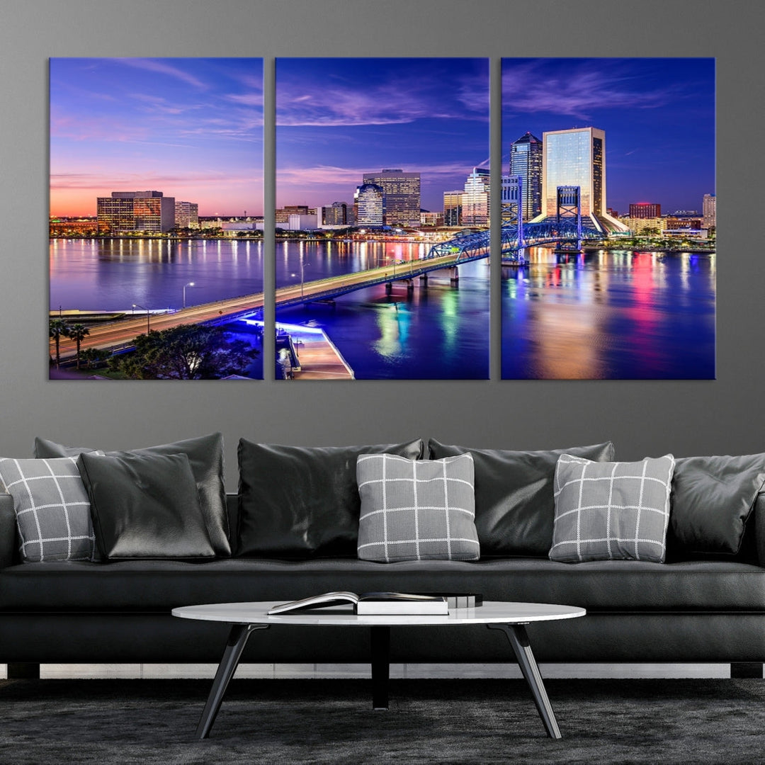 A triptych of the Jacksonville Wall Art Canvas Print, showcasing a cityscape at dusk with a river and illuminated buildings, is elegantly displayed. These museum-quality canvases are coated with UV protection to ensure long-lasting vibrancy.