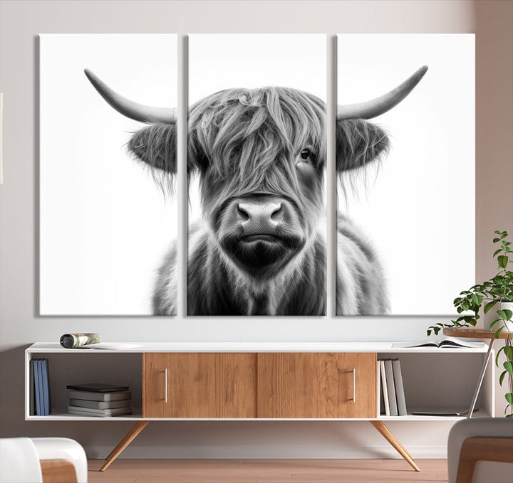 A three-panel wall art from the Highland Cow Animal Canvas series showcases a long-haired, large-horned cow. This Texas Cattle Art Print is crafted on museum-quality canvas with a UV-protective coating, making it an ideal addition to transform your living room.