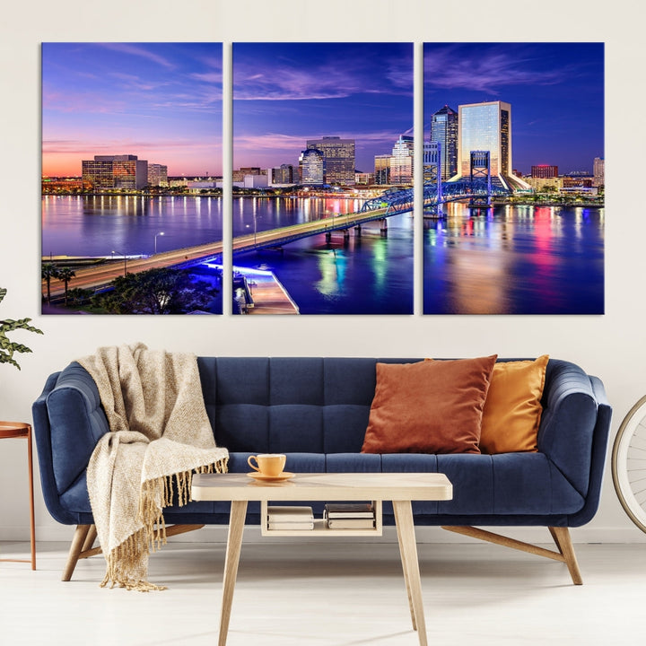 A triptych of the Jacksonville Wall Art Canvas Print, showcasing a cityscape at dusk with a river and illuminated buildings, is elegantly displayed. These museum-quality canvases are coated with UV protection to ensure long-lasting vibrancy.