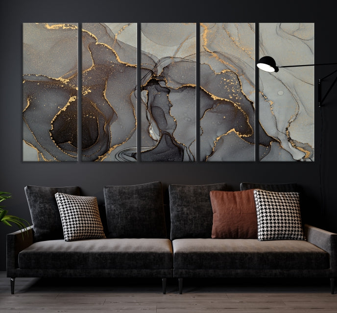 The Gray Marble Fluid Effect Wall Art Abstract Canvas Wall Art Print is a museum-quality canvas featuring triptych abstract art with swirling gray and gold patterns. Complete with a UV-protective coating, this piece of artwork arrives ready to hang, effortlessly elevating your living space.