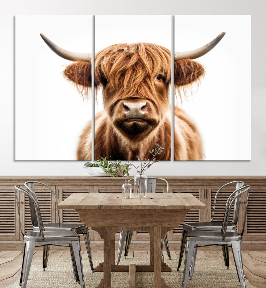 A Scottish Highland Cow Canvas Print, featuring a trio of panels depicting a long-haired, large-horned Highland cow on museum-quality canvas with UV protection, was displayed.