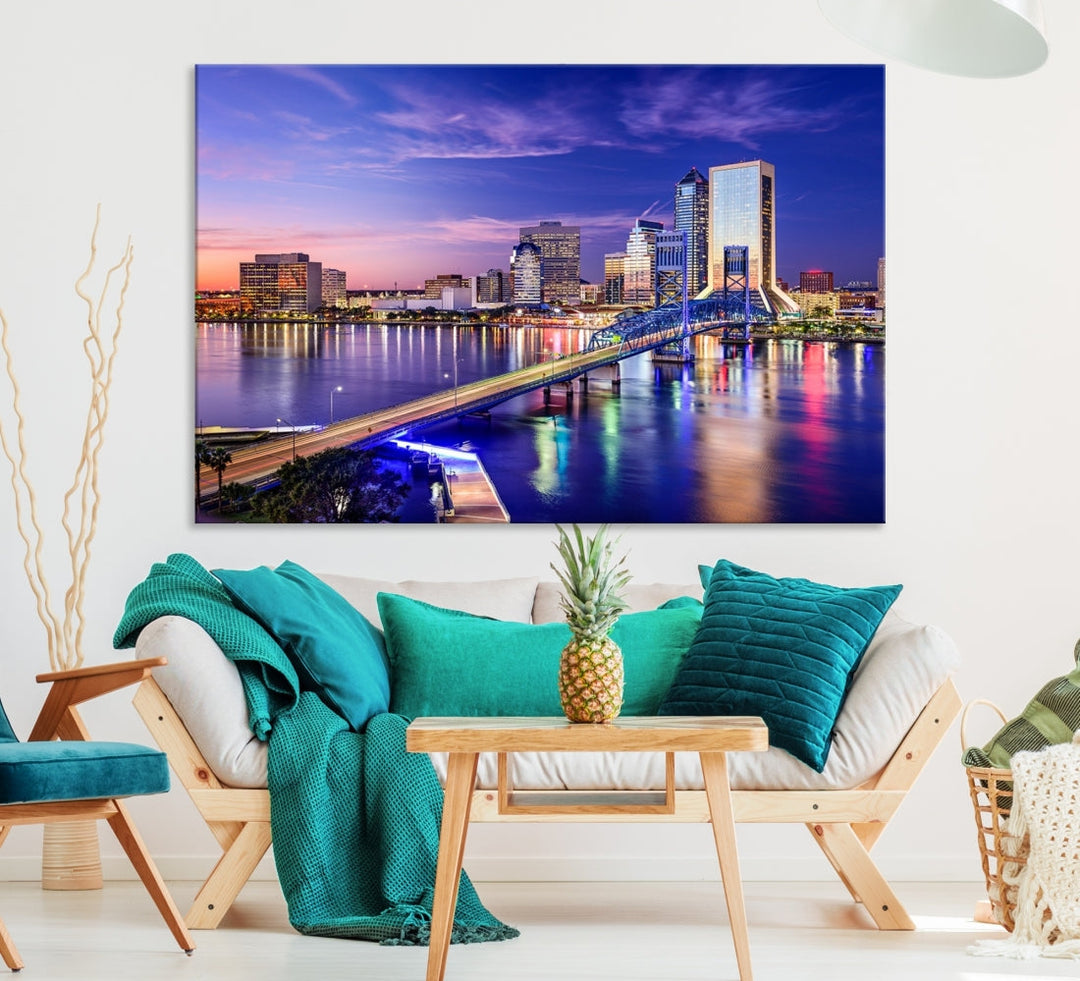 A triptych of the Jacksonville Wall Art Canvas Print, showcasing a cityscape at dusk with a river and illuminated buildings, is elegantly displayed. These museum-quality canvases are coated with UV protection to ensure long-lasting vibrancy.