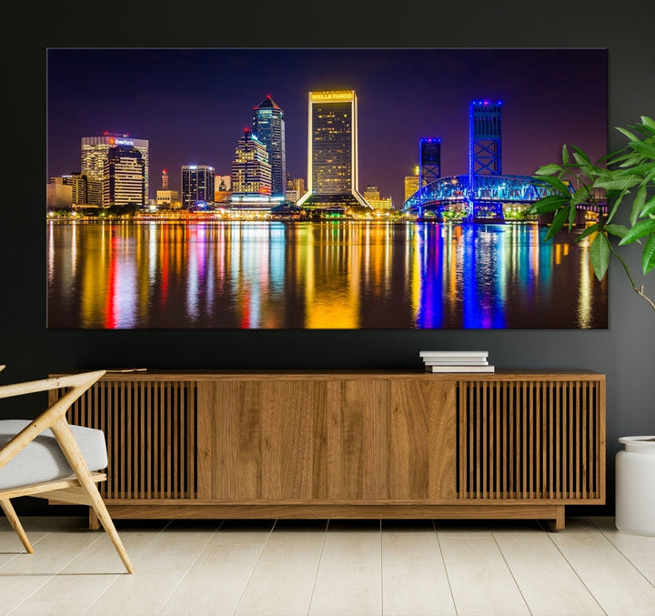 The Jacksonville City cityscape wall art captures a vibrant city skyline at night with colorful reflections in the water and is elegantly displayed on museum-quality gallery wrapped canvas.