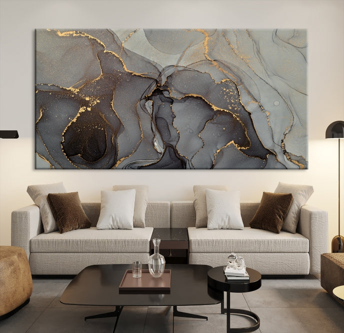 The Gray Marble Fluid Effect Wall Art Abstract Canvas Wall Art Print is a museum-quality canvas featuring triptych abstract art with swirling gray and gold patterns. Complete with a UV-protective coating, this piece of artwork arrives ready to hang, effortlessly elevating your living space.