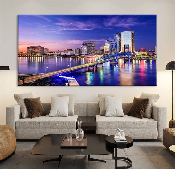 A triptych of the Jacksonville Wall Art Canvas Print, showcasing a cityscape at dusk with a river and illuminated buildings, is elegantly displayed. These museum-quality canvases are coated with UV protection to ensure long-lasting vibrancy.