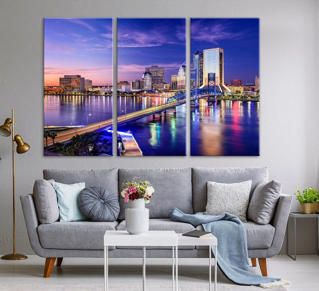 A triptych of the Jacksonville Wall Art Canvas Print, showcasing a cityscape at dusk with a river and illuminated buildings, is elegantly displayed. These museum-quality canvases are coated with UV protection to ensure long-lasting vibrancy.