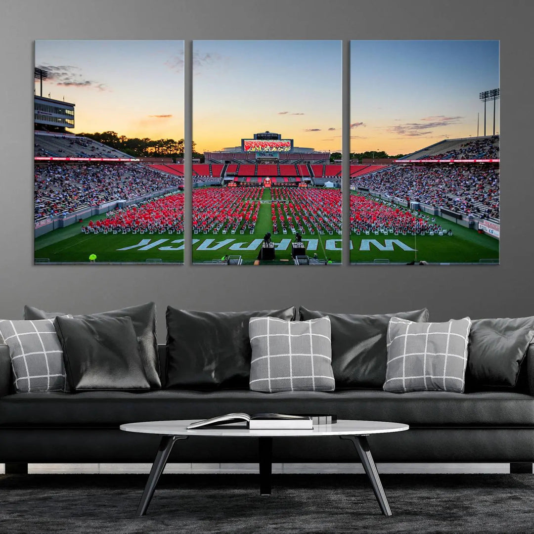 The wall art in the living room features the NC State Wolfpack Football Team Print, beautifully depicting Raleigh's Carter-Finley Stadium at sunset with a crowd dressed in red uniforms. Its gallery-quality finish on premium canvas transforms the scene into captivating artwork.