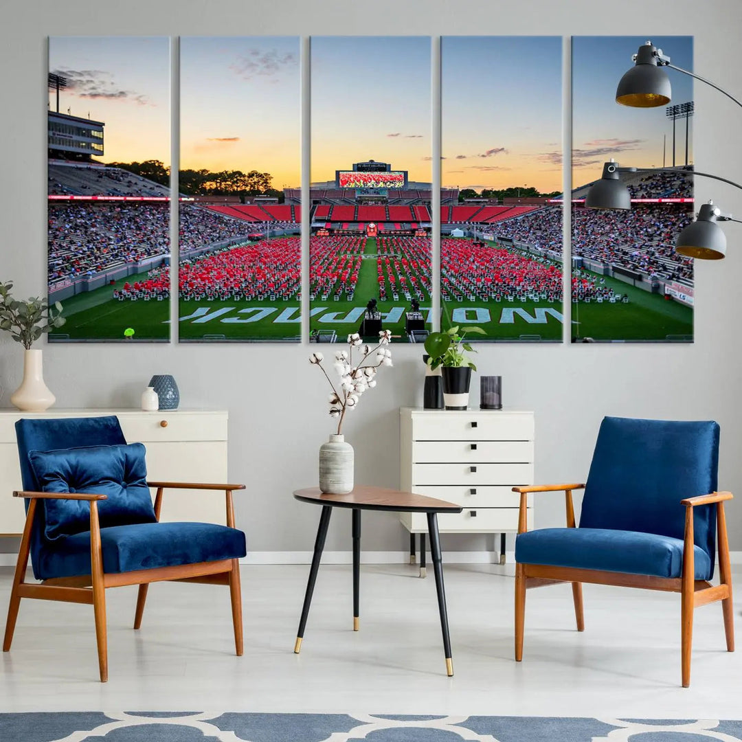 The wall art in the living room features the NC State Wolfpack Football Team Print, beautifully depicting Raleigh's Carter-Finley Stadium at sunset with a crowd dressed in red uniforms. Its gallery-quality finish on premium canvas transforms the scene into captivating artwork.