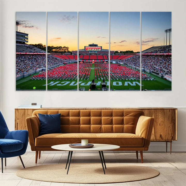 The wall art in the living room features the NC State Wolfpack Football Team Print, beautifully depicting Raleigh's Carter-Finley Stadium at sunset with a crowd dressed in red uniforms. Its gallery-quality finish on premium canvas transforms the scene into captivating artwork.