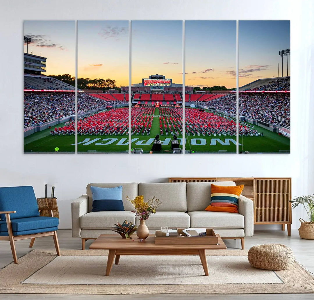 The wall art in the living room features the NC State Wolfpack Football Team Print, beautifully depicting Raleigh's Carter-Finley Stadium at sunset with a crowd dressed in red uniforms. Its gallery-quality finish on premium canvas transforms the scene into captivating artwork.