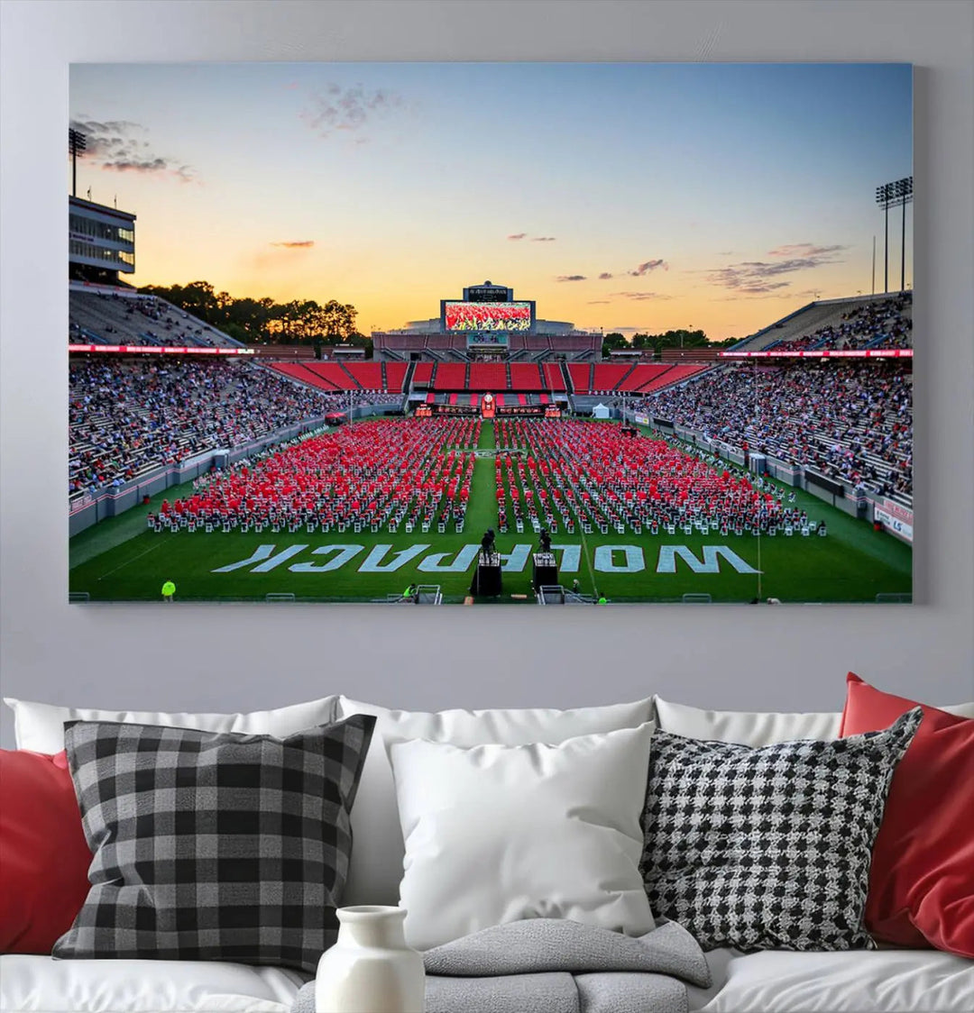 The wall art in the living room features the NC State Wolfpack Football Team Print, beautifully depicting Raleigh's Carter-Finley Stadium at sunset with a crowd dressed in red uniforms. Its gallery-quality finish on premium canvas transforms the scene into captivating artwork.