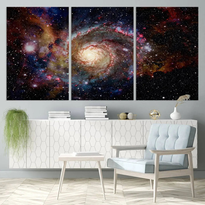 The modern living room is adorned with the Nebula and Galaxies in Space Wall Art, a spiral galaxy canvas print that showcases high-resolution details on museum-quality canvas. The UV-protective coating ensures its stunning allure is preserved.