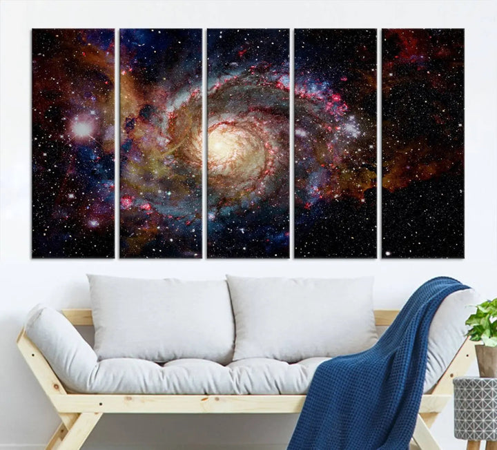 The modern living room is adorned with the Nebula and Galaxies in Space Wall Art, a spiral galaxy canvas print that showcases high-resolution details on museum-quality canvas. The UV-protective coating ensures its stunning allure is preserved.