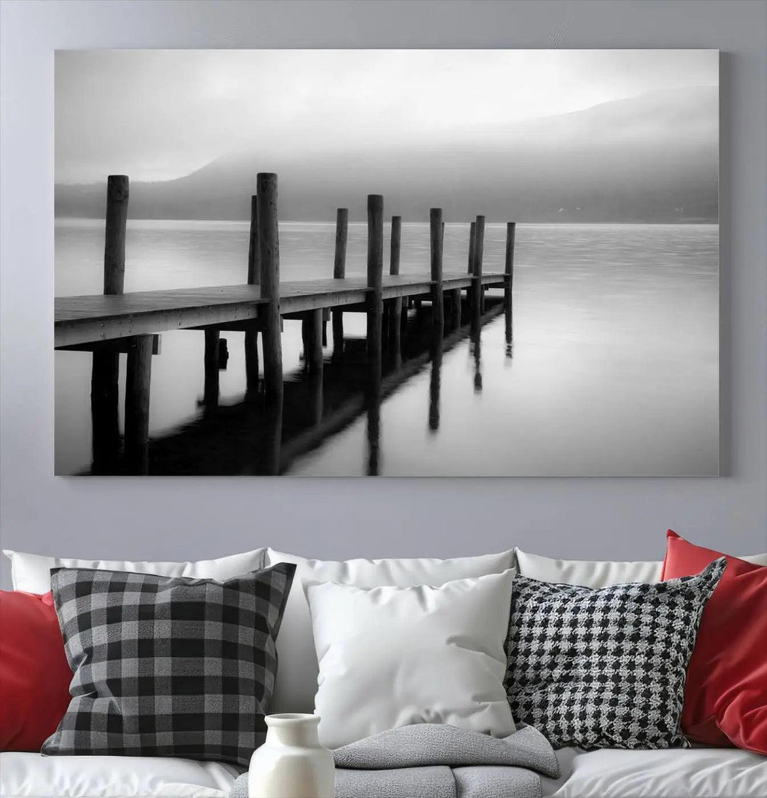 The "Ocean Beach Canvas Wall Art" is a black-and-white triptych depicting a serene dock over water.