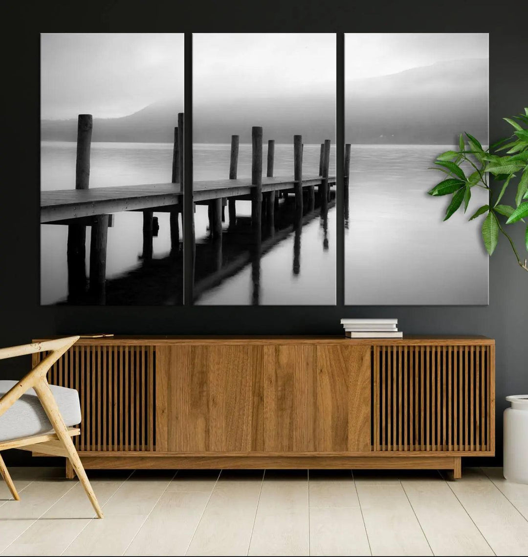 The "Ocean Beach Canvas Wall Art" is a black-and-white triptych depicting a serene dock over water.