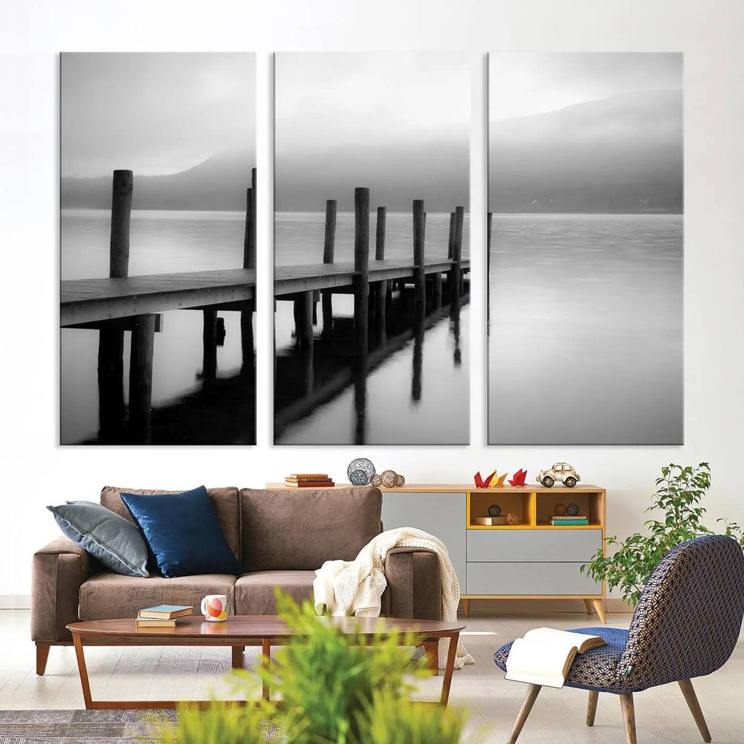 The "Ocean Beach Canvas Wall Art" is a black-and-white triptych depicting a serene dock over water.