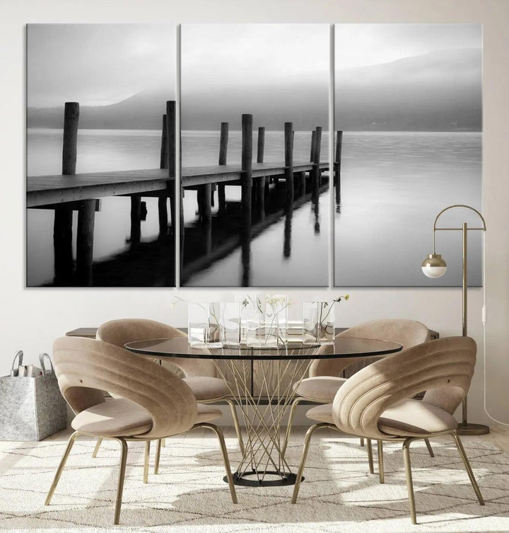 The "Ocean Beach Canvas Wall Art" is a black-and-white triptych depicting a serene dock over water.