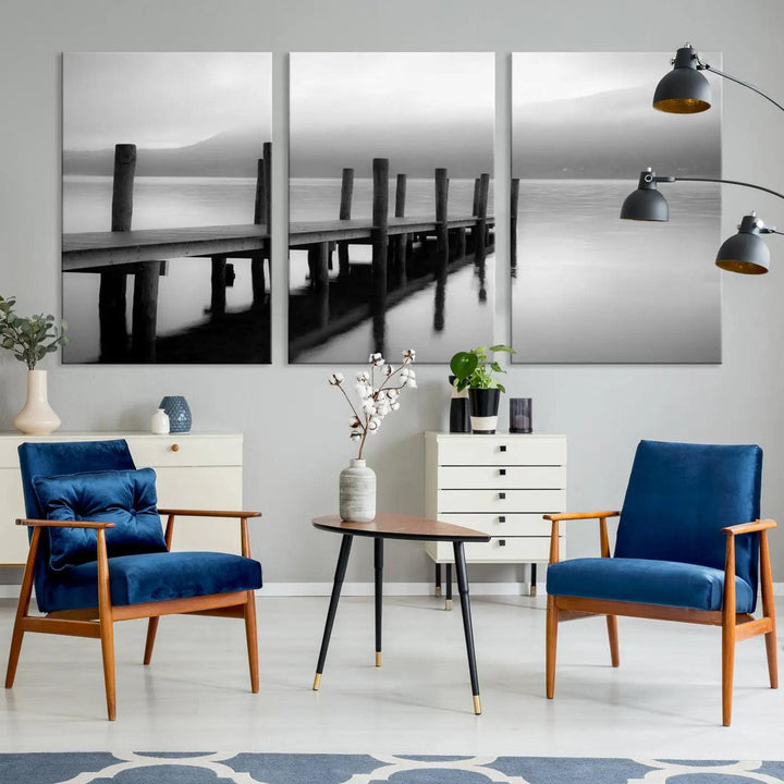 The "Ocean Beach Canvas Wall Art" is a black-and-white triptych depicting a serene dock over water.