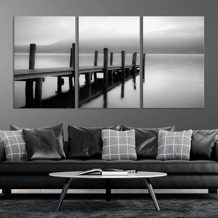 The "Ocean Beach Canvas Wall Art" is a black-and-white triptych depicting a serene dock over water.