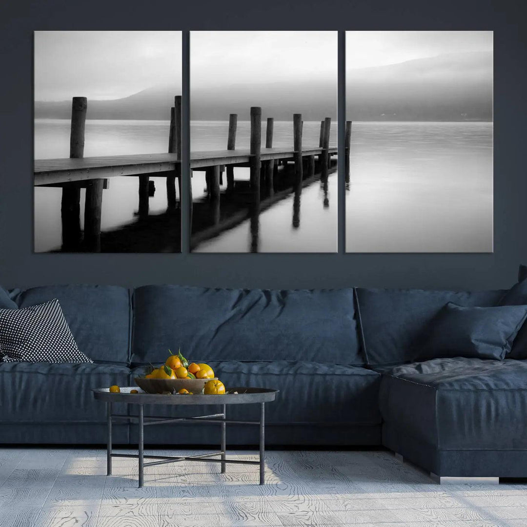 The "Ocean Beach Canvas Wall Art" is a black-and-white triptych depicting a serene dock over water.