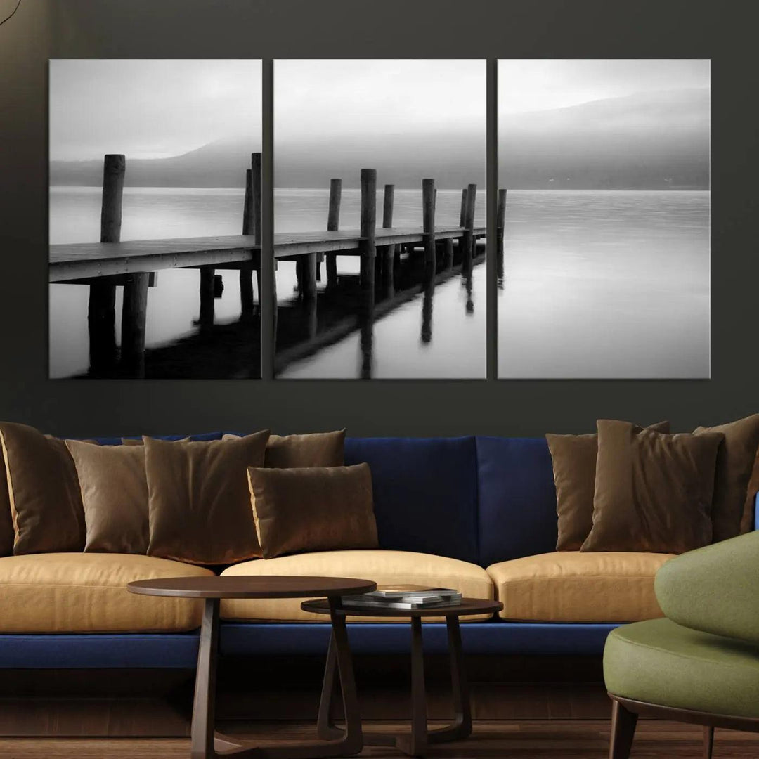 The "Ocean Beach Canvas Wall Art" is a black-and-white triptych depicting a serene dock over water.