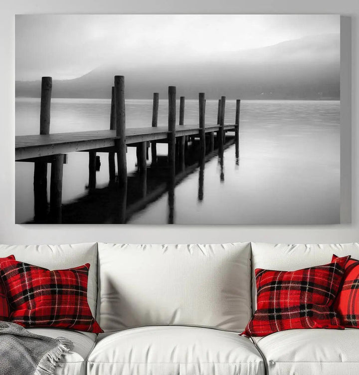 The "Ocean Beach Canvas Wall Art" is a black-and-white triptych depicting a serene dock over water.