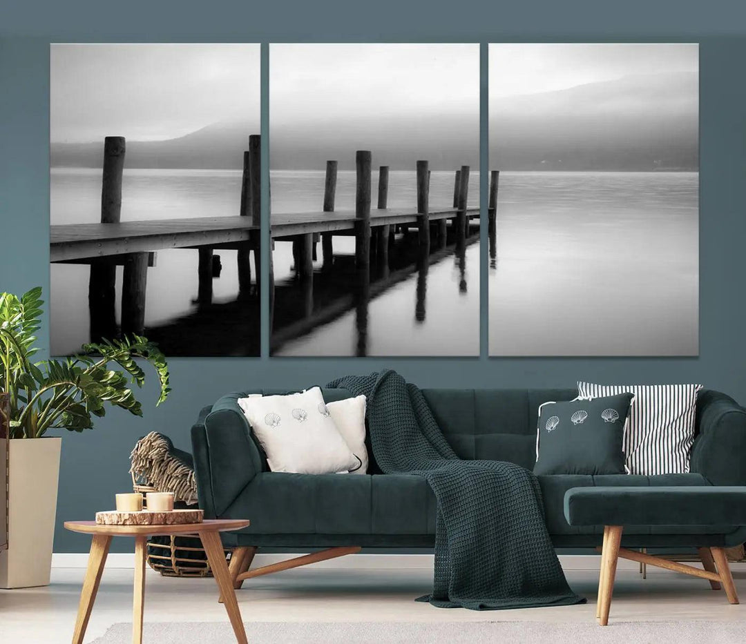 The "Ocean Beach Canvas Wall Art" is a black-and-white triptych depicting a serene dock over water.