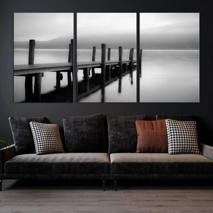 The "Ocean Beach Canvas Wall Art" is a black-and-white triptych depicting a serene dock over water.