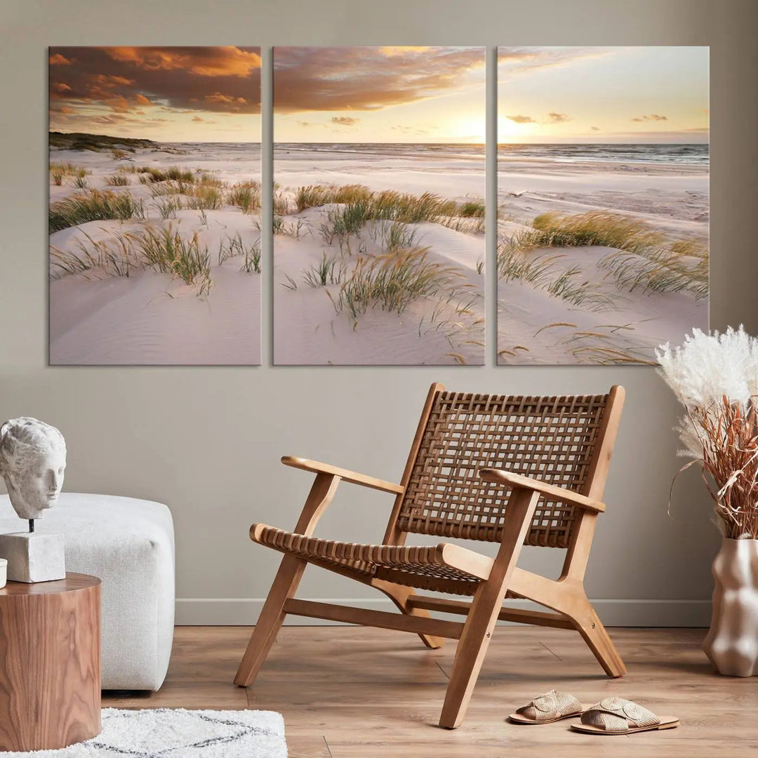 A triptych of the Ocean Beach Wall Art Canvas Print Sunset Artwork Print Coastal Wall Art showcases a serene beach landscape with sand dunes and grasses, gallery wrapped on museum-quality canvas.