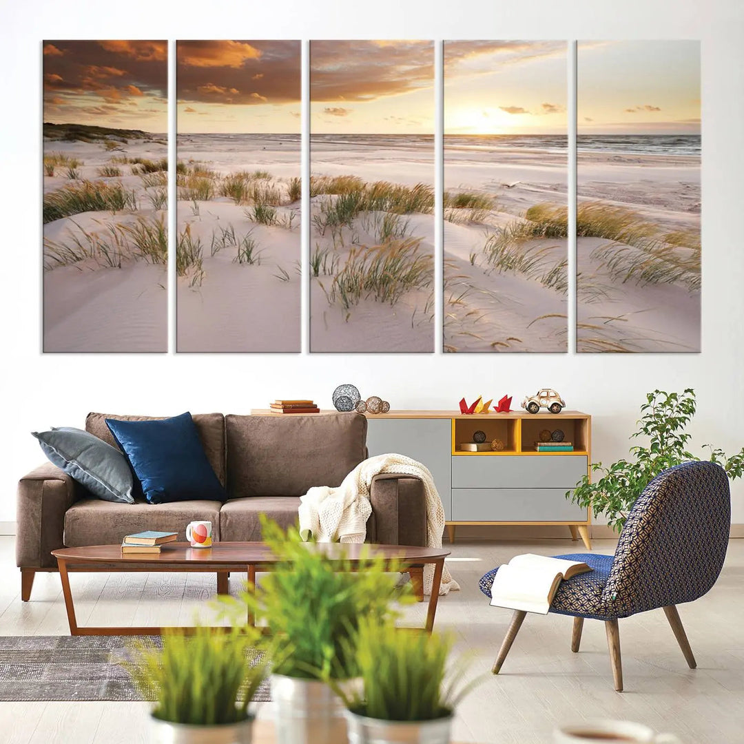 A triptych of the Ocean Beach Wall Art Canvas Print Sunset Artwork Print Coastal Wall Art showcases a serene beach landscape with sand dunes and grasses, gallery wrapped on museum-quality canvas.