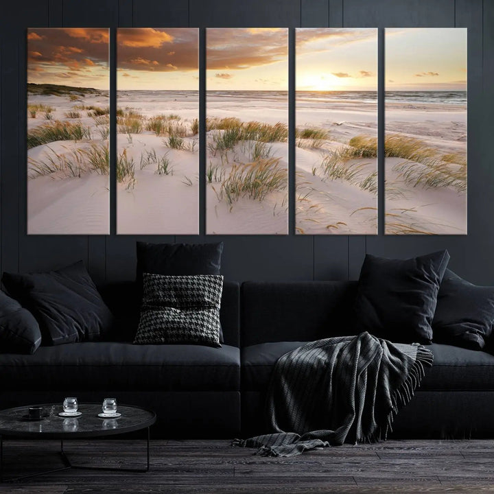 A triptych of the Ocean Beach Wall Art Canvas Print Sunset Artwork Print Coastal Wall Art showcases a serene beach landscape with sand dunes and grasses, gallery wrapped on museum-quality canvas.