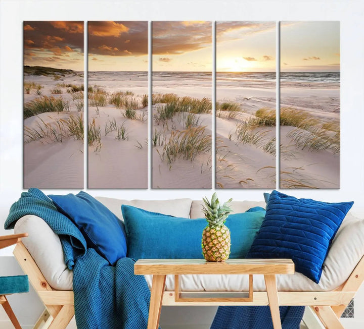 A triptych of the Ocean Beach Wall Art Canvas Print Sunset Artwork Print Coastal Wall Art showcases a serene beach landscape with sand dunes and grasses, gallery wrapped on museum-quality canvas.