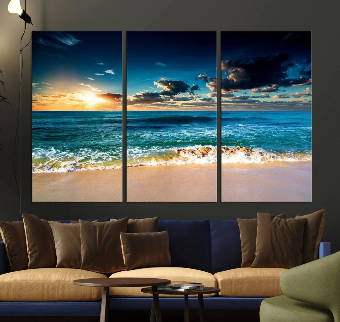 The Ocean Breeze Beach Sunset Wall Art Canvas Print—a captivating triptych of a beach sunset—adds a stunning coastal charm to the room, making it ideal for home or cabin decor.