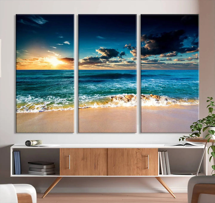 The Ocean Breeze Beach Sunset Wall Art Canvas Print—a captivating triptych of a beach sunset—adds a stunning coastal charm to the room, making it ideal for home or cabin decor.